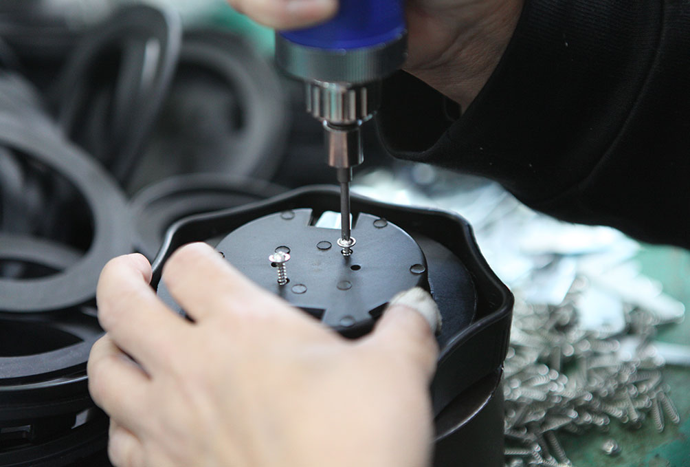 Technician assembling a locking fuel cap